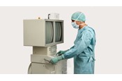Medizinische Fachkraft vor einer abgedeckten Maschine